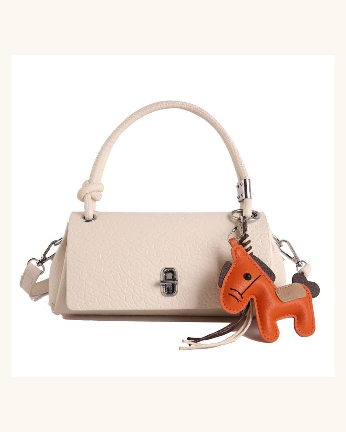 Cream women's handbag with orange charm